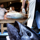 Masaki Kimura (left) cuts the sold tuna. (EPA/Kiyoshi Ota)